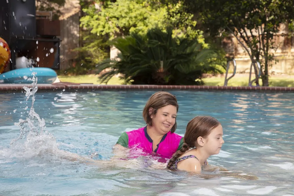 Crystal teaching a student to swim